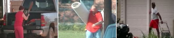 A man holding a roll of carpet.